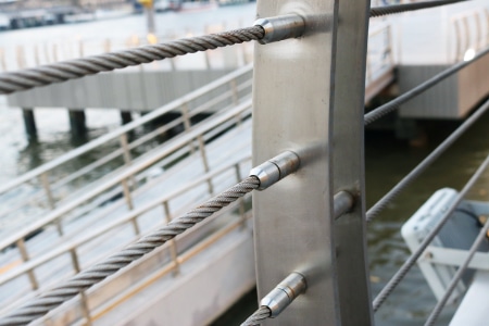 Stainless steel wire rope with threaded stud joint install connect to railing pole structure.